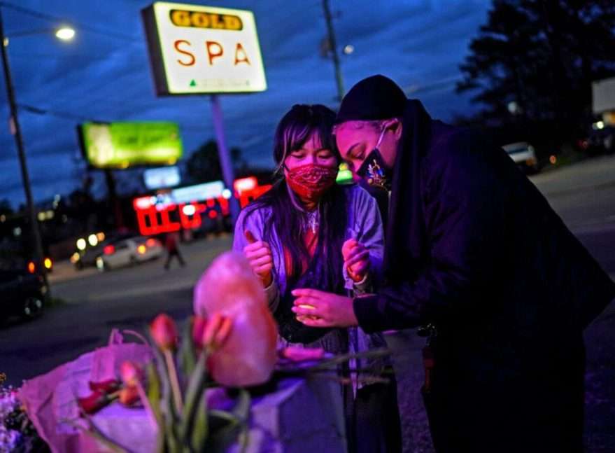 Women at a memorial outside the Gold Spa in Atlanta, where three Korean women were shot and killed on Tuesday. Credit: Chang W. Lee - "The New York Times"