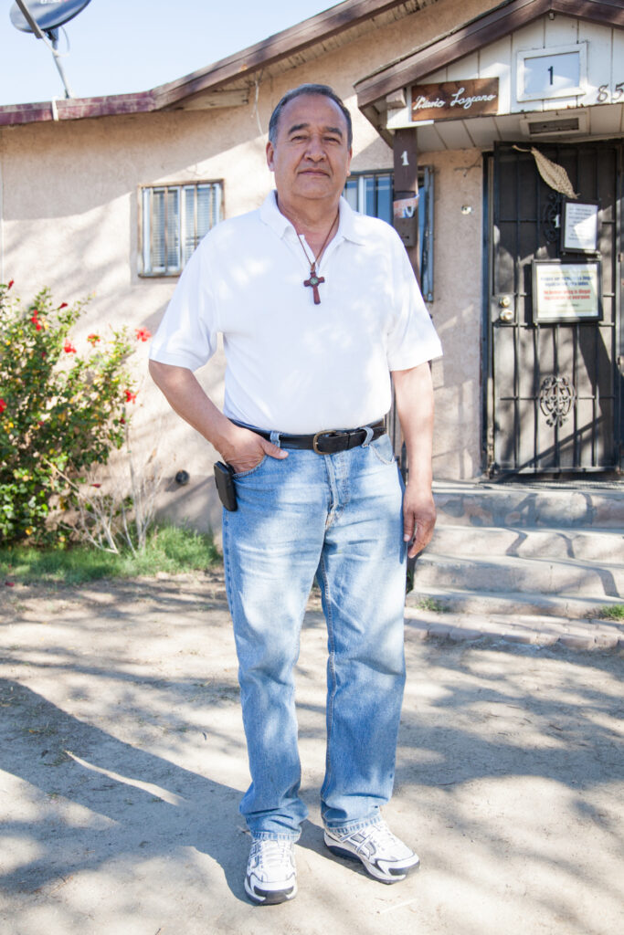 Jose Mario Lazcano in front of his home in Coachella. Born in Mexico City, Mario was present during the events of the 1968 Tlatelolco Massacre. This contributed to him becoming a passionate advocate for human rights. He came to the U.S. in 1984 to work in the fields. During the Amnesty of 1986 his labor union trained him to assist people with the application and process. This experience taught him the value of having legal residency. He himself applied for and was granted legal status.