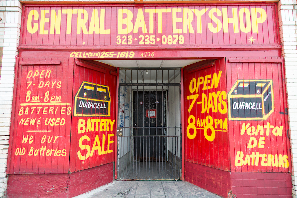 Central Battery Shop at 4756 S. Central Avenue, south of downtown Los Angeles, is entirely covered in red paint, yellow lettering and freehand portraits of batteries.