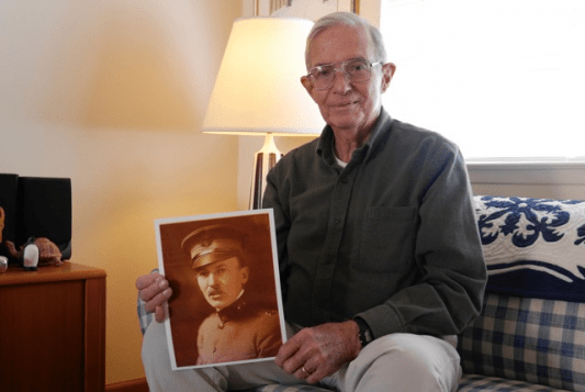 Retired chemist L. Philip Reiss, 79, with a photo of his grandfather, Winford Lee Lewis, the inventor of the chemical warfare agent lewisite. (Photo by Theo Emery).