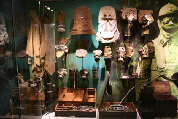 Gas mask display at the Memorial Museum Passchendaele 1917 in Zonnebeke, Belgium. The earliest rudimentary British masks are at the center top, with later, more advanced small box respirator to its right.