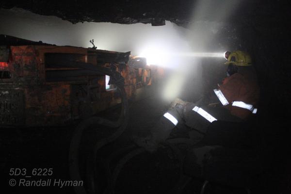 Miner runs coal cutter in depths of Mine 7 in Longyearbyen, Svalbard, Norway.