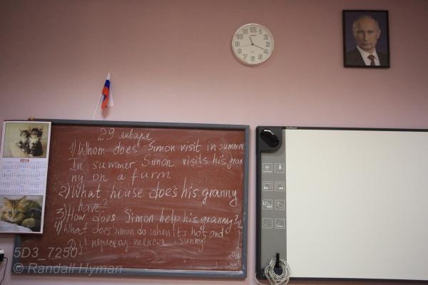 Putin portrait overlooks blackboard English lessons in primary school in Barentsburg, Svalbard, Norway.