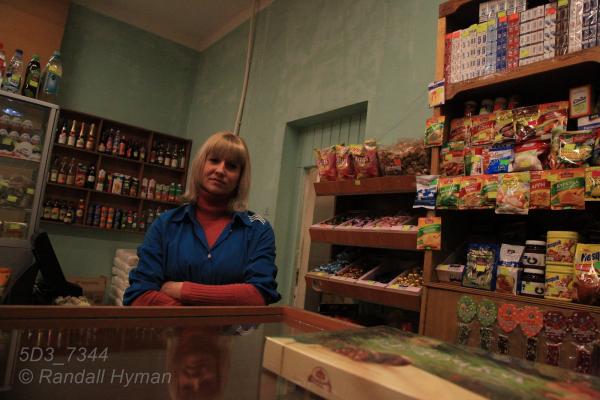 Store clerk stands amid Russian-labelled products in company store in Barentsburg, Svalbard, Norway.