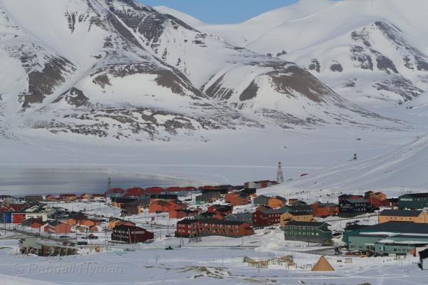 Modern town nestles amid snowy mountains in Longyearbyen, Svalbard, Norway.