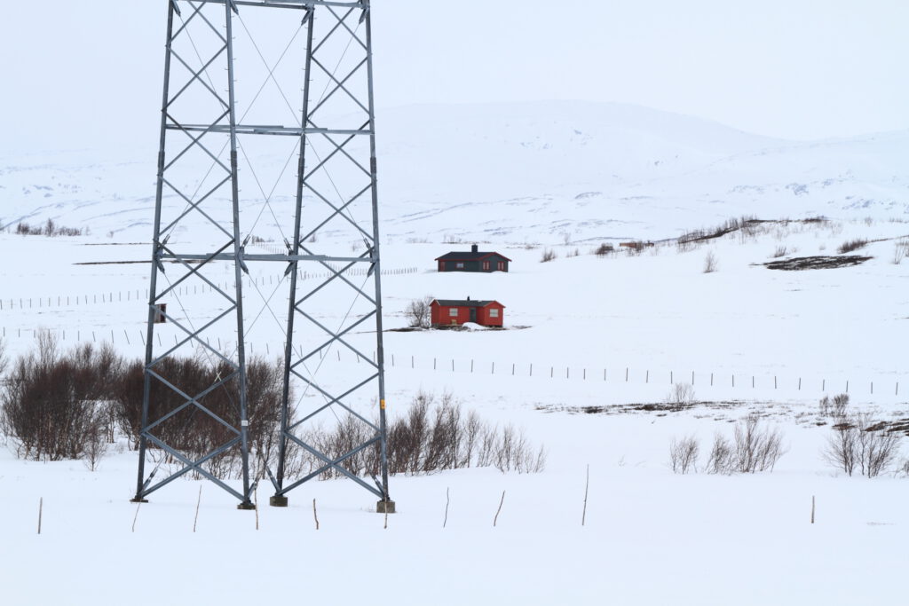 Power lines, fences and cottages fragment winter reindeer pastures in Sennalandet, Finnmark County, Norway.