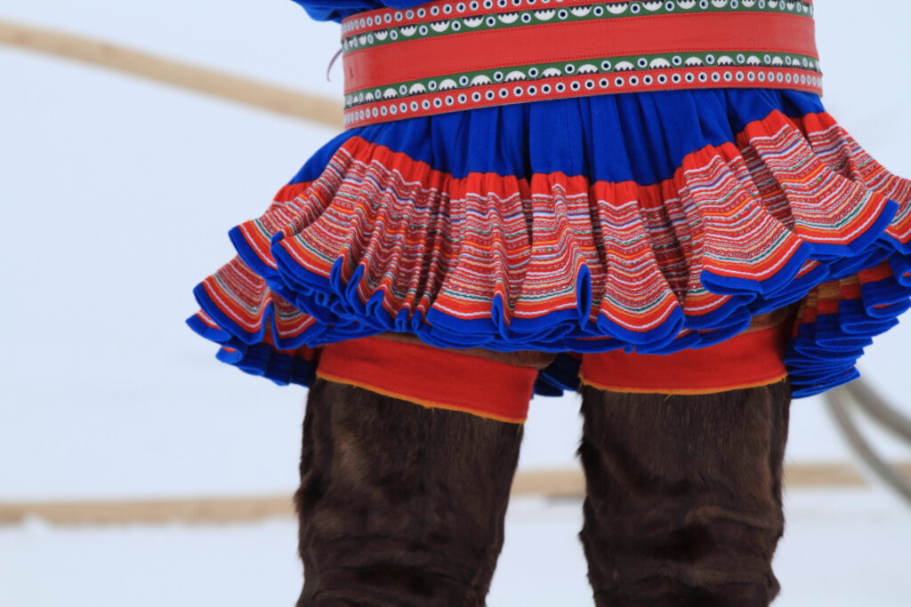 Detailed close view of reindeer leggings and traditional Sami folk attire, called a gaktí, on a man in Kautokeino, Finnmark, Norway.