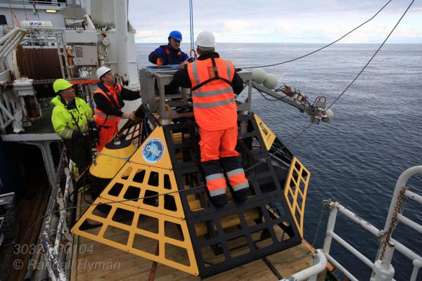 Crew and engineers aboard R/V Helmer Hanssen prepare to deploy specially-designed lander commissioned by Norway's Centre for Arctic Gas Hydrate, Environment and Climate (CAGE) for one-year mission monitoring Arctic Ocean methane off west coast of Spitsbergen, Svalbard archipelago, Norway.