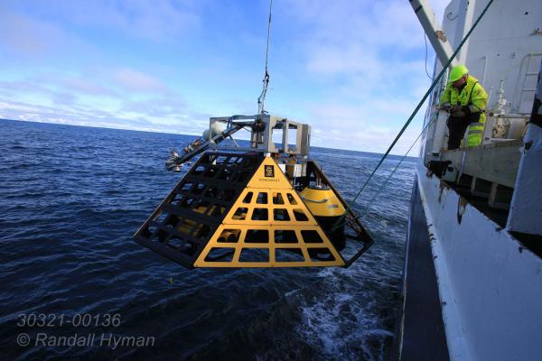 Crew and engineers aboard R/V Helmer Hanssen deploy specially-designed lander commissioned by Norway's Centre for Arctic Gas Hydrate, Environment and Climate (CAGE) for one-year mission monitoring Arctic Ocean methane off west coast of Spitsbergen, Svalbard archipelago, Norway.