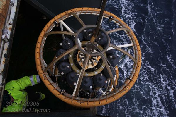 Rosette carousel of water samples collected from various depths is winched aboard R/V Helmer Hanssen during CAGE research cruise investigating seafloor methane in the Arctic Ocean; Svalbard archipelago, Norway.