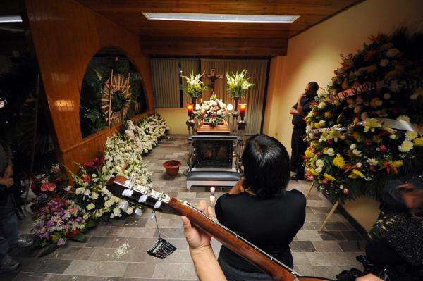 The funeral of Regina Martinez, where a large floral display from ex-Gov. Javier Duarte can be seen to the right. Photo: Ruben Espinosa, Proceso