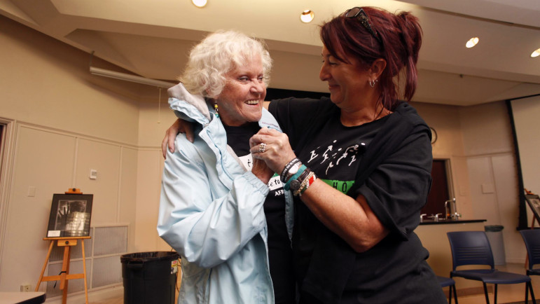 Marietta Jaeger embraces SueZann Bosler, a Journey of Hope co-founder from Florida. An intruder fatally stabbed Bosler’s father and stabbed Bosler in the back and head when she tried to help him.