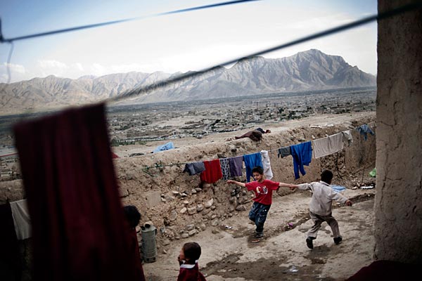 Children of widows play on "the hill that women built" which overlooks Kabul. The widows say they feel safe on the steep hill, which because of its lack of water and minimal electricity, keeps others from wanting their homes.