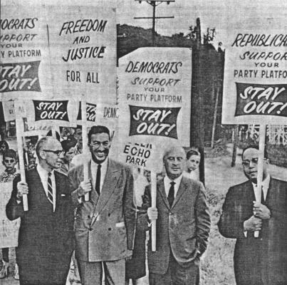 Throughout his political career, Powell was involved in civil rights activities. Here he engages in bipartisan picketing of the Glen Echo amusement park in suburban Maryland to protest segregation of its swimming pool. With him were U.S. Representatives Charles 0. Porter (D-OR.) at left; Seymour Halpern (R-NY) center and Charles C. Diggs (D-Ml) at right. Photo: AP/Wide World Photos