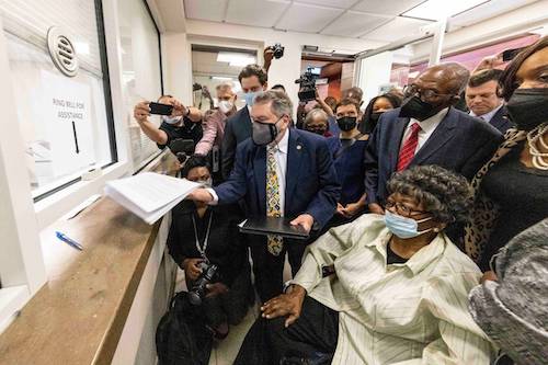 Claudette Colvin, seated, watches as her attorney Gar Blume files paperwork in juvenile court to have her juvenile record expunged, Tuesday, Oct. 26, 2021, in Montgomery, Ala. Colvin was arrested for not giving up her seat on a bus in 1955. Behind Colvin wearing a red tie is Fred Gray, her original attorney from the civil rights era. (AP Photo/Vasha Hunt) Vasha Hunt AP