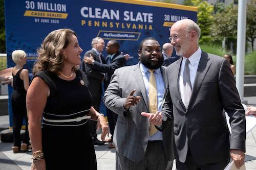 Pennsylvania Gov. Tom Wolf, right, walks with Rep. Sheryl Delozier, R-Cumberland, left, and Rep. Jordan Harris D-Philadelphia, during a “clean slate” news conference in Harrisburg, Pa., in 2019. State officials and other supporters touted the new phase of the legislation Friday in Harrisburg, calling the program a model for other states. Lower level criminal convictions will start to be automatically sealed under the law, touted as a way to give offenders a fresh start. Matt Rourke AP