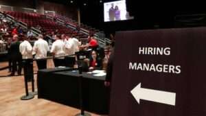 In this 2019 file photo, managers wait for job applicants at the Seminole Hard Rock Hotel & Casino Hollywood during a job fair in Hollywood, Fla. Several states are looking help people with criminal records, including offering certificates of rehabilitation and tax credits for employers who hire felons. WILFREDO LEE, FILE AP PHOTO