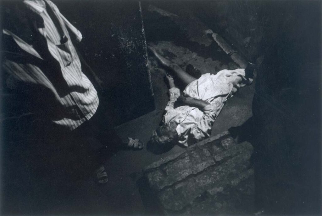 A drunk customer who has fallen down the stairs inside the brothel. 2001 © Zana BRISKI