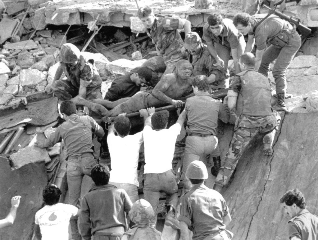 British soldiers give a hand in rescue operations at the site of the bomb-wrecked U.S. Marine command center near Beirut airport on October 23, 1983. A bomb-laden truck drove into the center collapsing the entire four story building.