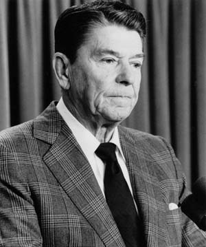 President Ronald Reagan pauses while talking with reporters in the White House Briefing Room. Reagan said that Marine and Pentagon commanders would not be punished for security lapses that preceded the October 23, 1983 truck bombing of Marine headquarters in Beirut. "If there is to be blame, it properly rests here in this office and with this president," Reagan said.