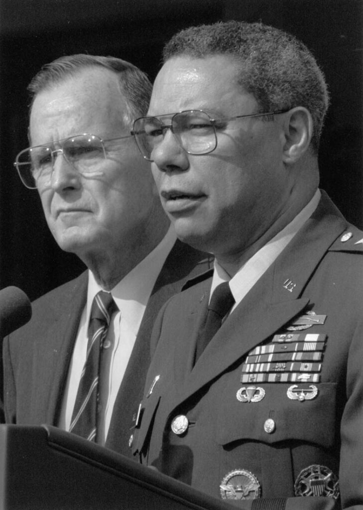 Joint Chiefs of Staff Chairman, Gen. Colin Powell, with President Bush at his side, addresses reporters May 23, 1991 in the White House Rose Garden after the President announced that he was reappointing Powell to a second term. Bush praised Powell for his advice and leadership in the war against Iraq and the invasion of Panama. (AP Photo/Marcy Nighswander)