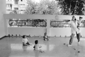 Nursery school teacher playing with toddlers.