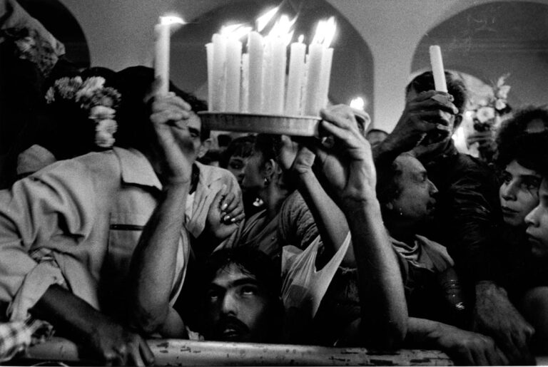 St. Lazarus’ devotees offer candles in Santiago de las Vegas, Cuba.