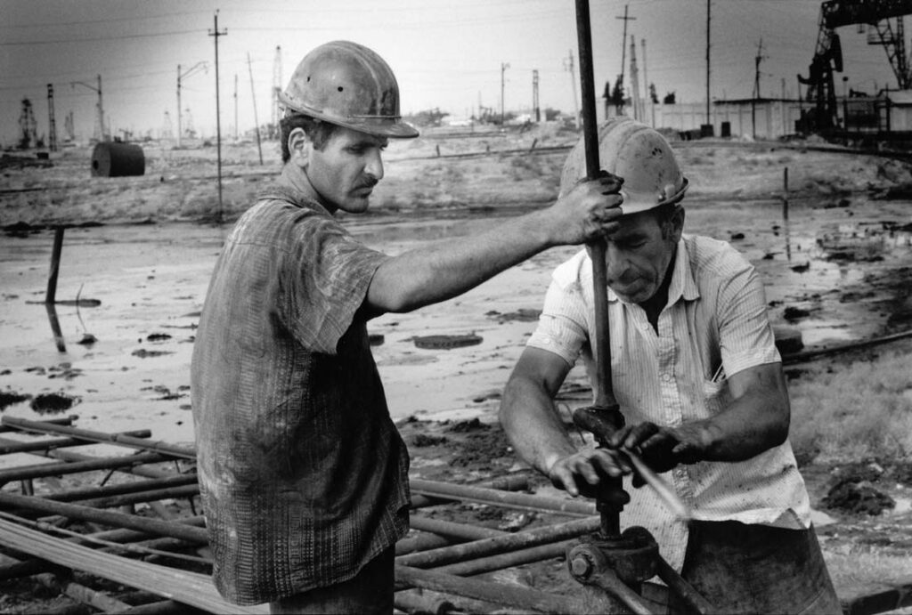 Oil workers putting a tap.