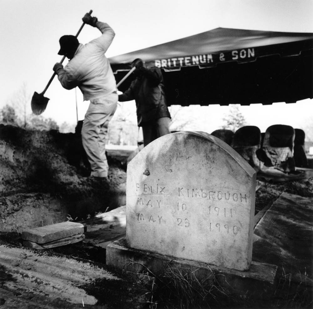 Workmen shovel dirt into the grave on hill country blues legend "Junior" Kimbrough in January of 1998 as he is put to rest beside his brother in the family cemetery in Hudsonville, MS. Kimbrough inspired and tutored several generations of musicians in the Mississippi hill country, including his sons Kinney and David who plan to keep going since the death of the family’s musical patriarch, and the club continues to be the central gathering place for local blues fans in the hill country as well a tourists from around the world drawn there by Kimbrough’s music and legacy. Today, younger musicians from the Kimbrough and Burnside families provide live music at the club every Sunday night to keep hill country blues traditions alive.