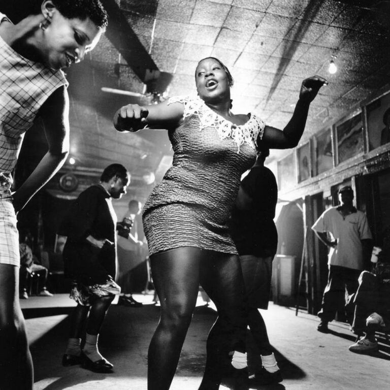 Dancers hit the floor at Junior Kimbrough’s juke joint in Chulahoma, MS as Junior’s son, guitarist David Kimbrough Jr., plays and sings one of his father’s songs. Starting with his house parties in the fifties and then with the opening of his first juke joint in 1991, Kimbrough established himself as the musical and social center for the African-American community in Marshall County and the surrounding area. Junior’s son and drummer Kinney Kimbrough explains why locals have always responded to his father’s musc: "People just loved the rhythm of his music," says the younger Kimbrough. "It make them move."