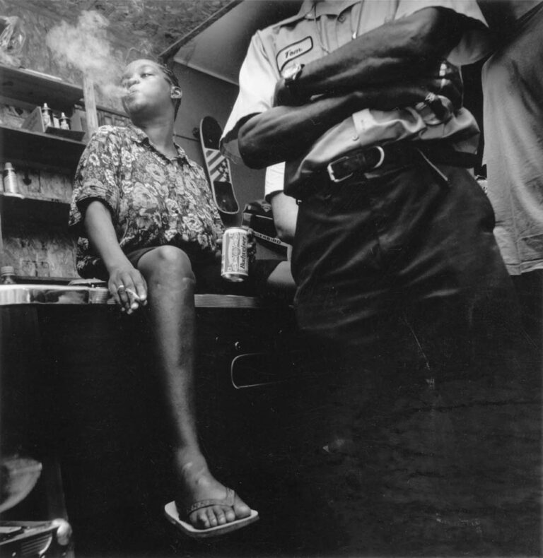 A woman sits on a pool table listening to California blues man Robert Walker perform in his hometown of Bobo, MS, at Thompson Grocery. Until it burned in December of 1996, Thompson grocery was something of an anomaly in modern-day Mississippi. White-owned in a mostly black small town, the business served as a general store, pool hall, juke joint and gathering place for both blacks and whites in the community, not unlike similar establishments in the antebellum south before segregation forced blacks and whites to socialize in separate clubs.