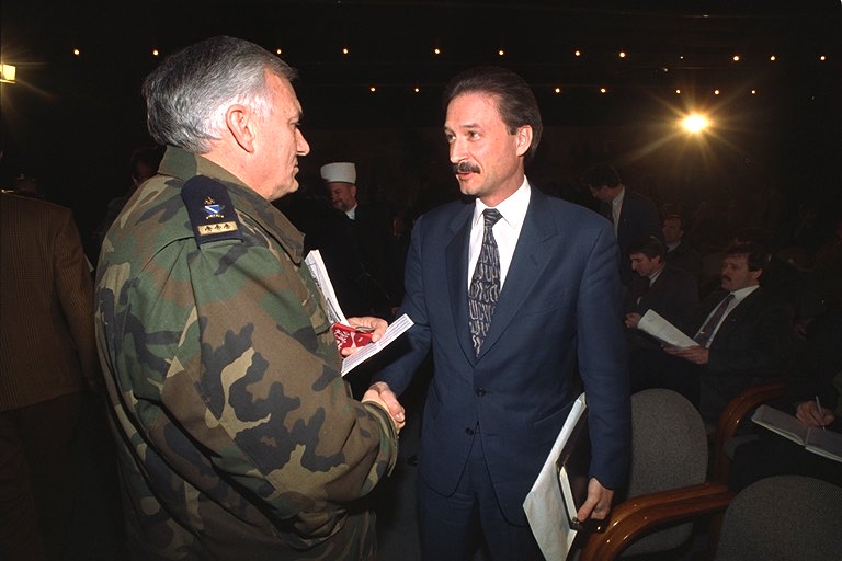 Victor Jackovich, right, the first U.S. ambassador to Bosnia, speaks with Bosnian Army Gen. Jovan Divjak, an ethnic Serb, during a break in the Sarajevo Parliament session in 1994. Jackovich was one of the U.S. officials not told of Washington's policy change on Iranian arms to Bosnia.