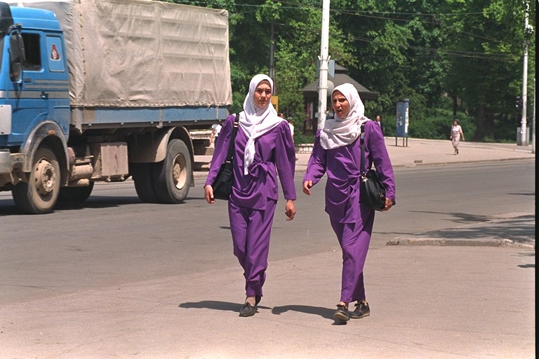 Two young women in traditional Muslim dress walk through Sarajevo in May, 1994. Though once a cosmopolitan Balkan capital, Sarajevo saw increasing signs of Islamic influence throughout the war, reflecting the growing influence of Muslim countries like Iran as well as a general turn toward religion to find comfort from the depravities of war.