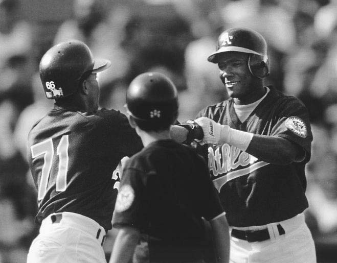 Miguel Tejada is congratulated by his new teammates after making a good impression in his first major league game.