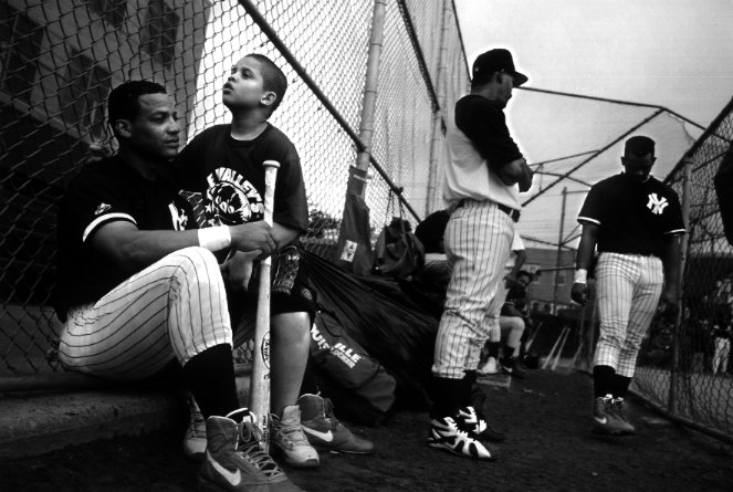 The Pedrin Zorrilla Baseball League is known as the toughest semi-pro team in New York. The teams are made up mostly of ex-minor leaguers. Angelo Tejeda, 29, center fielder for the Yankee team, watches the game with his son, Miguel Angel, 9. Tejeda played four years in the Texas Rangers organization, two of them in Single-A ball. He was released in 1986 at the age of 19 without explanation. He joined the large number of Latin players adrift within the game, the disposables of baseball.