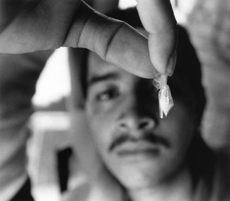 “Spider” triumphantly displays a bag of cocaine in El Salvador. An amount this size costs 50 colones, or $5.75 — nearly a day and a half’s wages at the Salvadoran minimum wage. Cocaine addiction, once limited to the Salvadoran upper class, has become common in street gang life.