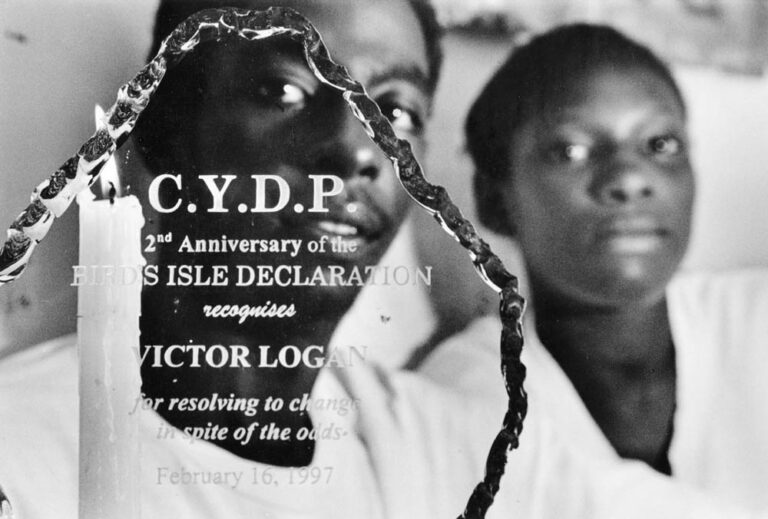 Victor Logan, "Stinga" displays an award recognizing his efforts to uphold the 1995 gang truce and to better himself through the Conscious Youth Development Program. It reads: CYDP 2nd Aniversary of the Bird’s Isle Declaration recognizes Victor Logan for resolving to change in spite of the odds. February 16, 1997. Photo by Donna DeCesare