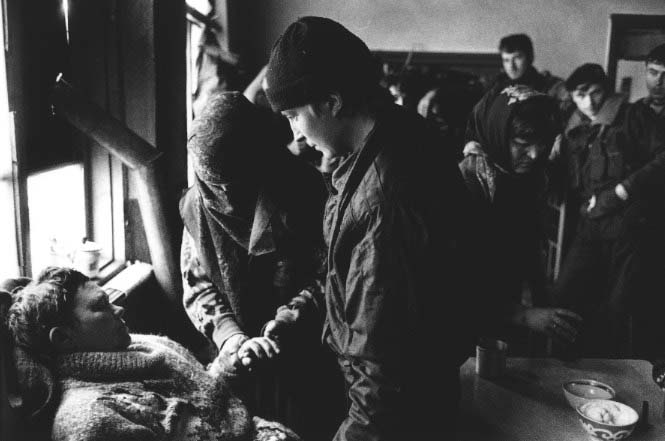 Here in a Chechen battalion base in the small town of Goiskoe, a 19-year-old Russian soldier from Stavropol, captured in December, 1995, is returned to his mother. After many months without mail from her son and repeated attempts to get information from the Russian army, she took up the search herself in Chechnya.