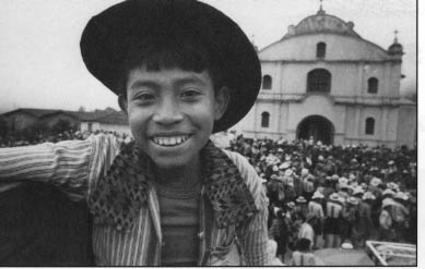 A boy enjoys the festive day as crowds gather in front of the church in Todos Santos.