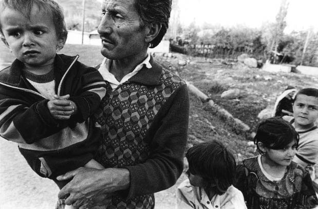 A Gharmi father of five tries to console his youngest, who is is plagued with intestinal worms. "7 inches long," the father says. Cut off from most assistance, either governmental or international, most families in Gharm lack soap and medicine. Like many Tajik children, these children suffer from scabies and chronic diarrhea.
