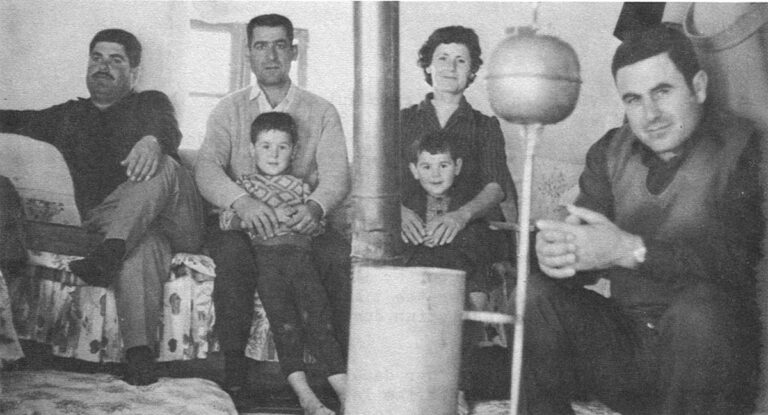 Around the oil stove at Im George's house. (from right): Elias, 33, Im George's second son, who is in the gendarmerie. Samira, mid-thirties, one of Im George's 7 daughters, Samira's husband, Ael, who works for the electricity company. A neighbor. The adults are in stocking feet, having shed their shoes when entering. The two boys go barefoot indoors and out, even though the elder ran a fever the day this picture was taken.