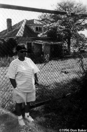 Shirley Davidson Ednes stands in front of the house where she lived as a girl. The fence was added later.