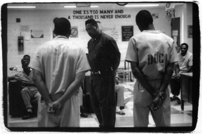 Henry Abraham (front), a counselor at the Substance Abuse Treatment Center in Chicago's Cook County jail, challenges inmates Greg Seawook (left) and Earl Jackson (right). He's conducting an encounter called "The Lifeline," which is held in front of a roomful of inmates. Photo by John Sundlof