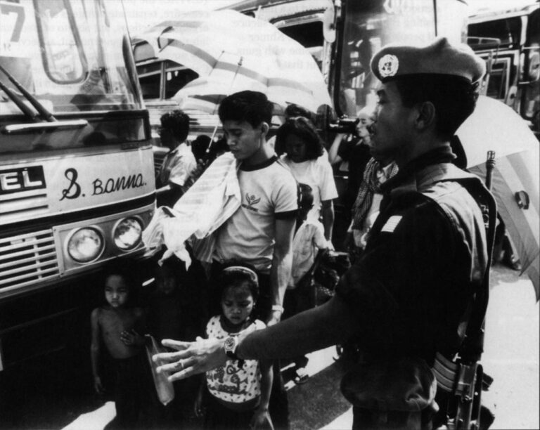 United Nations soldiers escort Cambodian refugees returning to Sisophon, Cambodia, in March 1992. Photo by Peter Charlesworth, JB Pictures