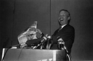 Buddy MacKay points to a headline in his hometown paper, the Ocala Star-Banner, proclaiming he won the Senate seat instead of Connie Mack. The photo appeared in the Palm Beach Post on Nov. 10, 1988 Photo by Bob Shanley, staff photographer, Palm Beach Post