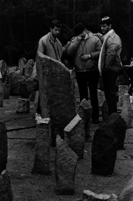 A trio mourns among rocks and stones at Treblinka that symbolize the Jewish towns that were annihilated by the Nazis in Poland. The Germans had given the road to the Treblinka gas chambers a name, Himmelfahrstrasse, the street to heaven. Technology permitted 150 people to kill 900,000 others in 18 months at a cost of 5-cents per person. Fewer than 40 Jews escaped from Treblinka.