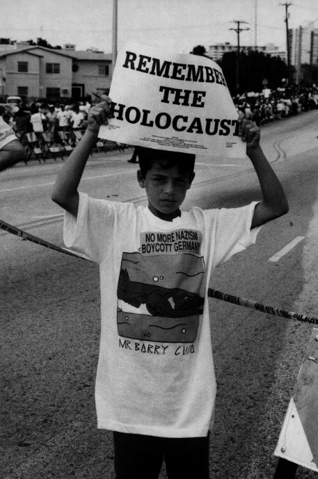 A boy demonstrates at the Holocaust Memorial in Miami Beach to counter a rally one block away by the Ku Klux Klan, skinheads and neo-Nazis. Survivors tales are heard more widely now than they were after the war. Post-war, survivors were an embarrassment to the churches, governments and Jews in the free world that had done little to save them.