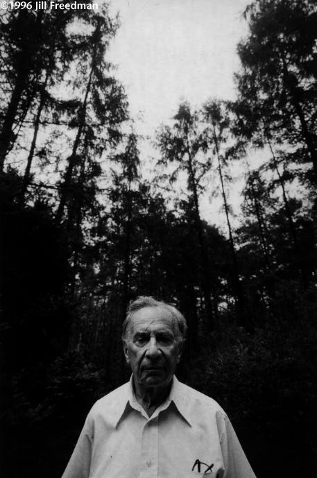 Lou Salton, founder of the Salton kitchenware company, stands in a national forest preserve ten miles from his Polish birthplace, Wieliczka. His father, grandmother, step-mother and step-sister were shot here, along with all Jews in the town. Poles dug pits and threw people in, burying many alive. Salton left Cracow in 1940, but his grandmother refused to go, so the rest of his family stayed and were killed. His mother and sister were choked in gas vans by carbon monoxide from diesel engines. The Saurer Company of Austria supplied the vans and they killed his relatives and 580,000 other Jews in Belzec. Salton, 82, returned to find his family's death place. Surviving Jews had dedicated a stone to their memory. There were no signs, no paths leading to it. We found it only with the help of an old peasant. Salton stood where his father had 52 years earlier. All around us the trees were dying of pollution from Cracow and from fallout from Chernobyl.