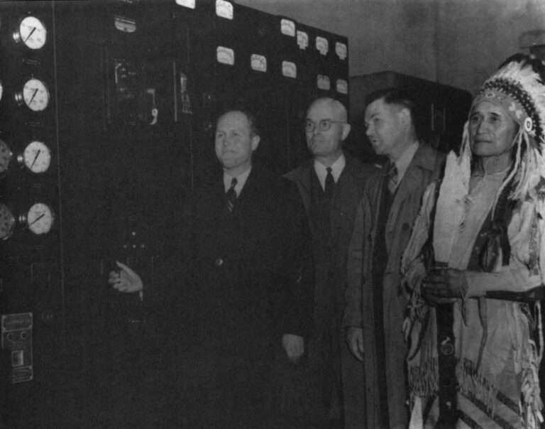 A Colville Indian chief stands with government engineers on March 22, 1941 as the switch is turned at the opening of the Grand Coulee Dam. Department of the Interior U.S. Bureau of Reclamation Grand Coulee Project