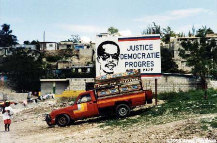This billboard was put up by the Port-au-Prince townhall. Under the de facto regime (that ended with the "immaculate invasion" by the Multinational Forces), even a newspaper clipping with Father Aristide's picture was reason enough to beat or jail the owner.